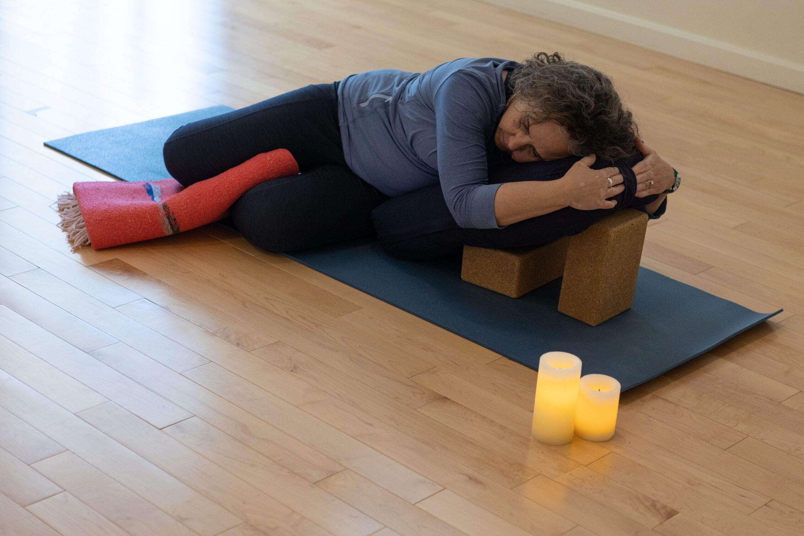 Woman in restorative spinal twist yoga pose
