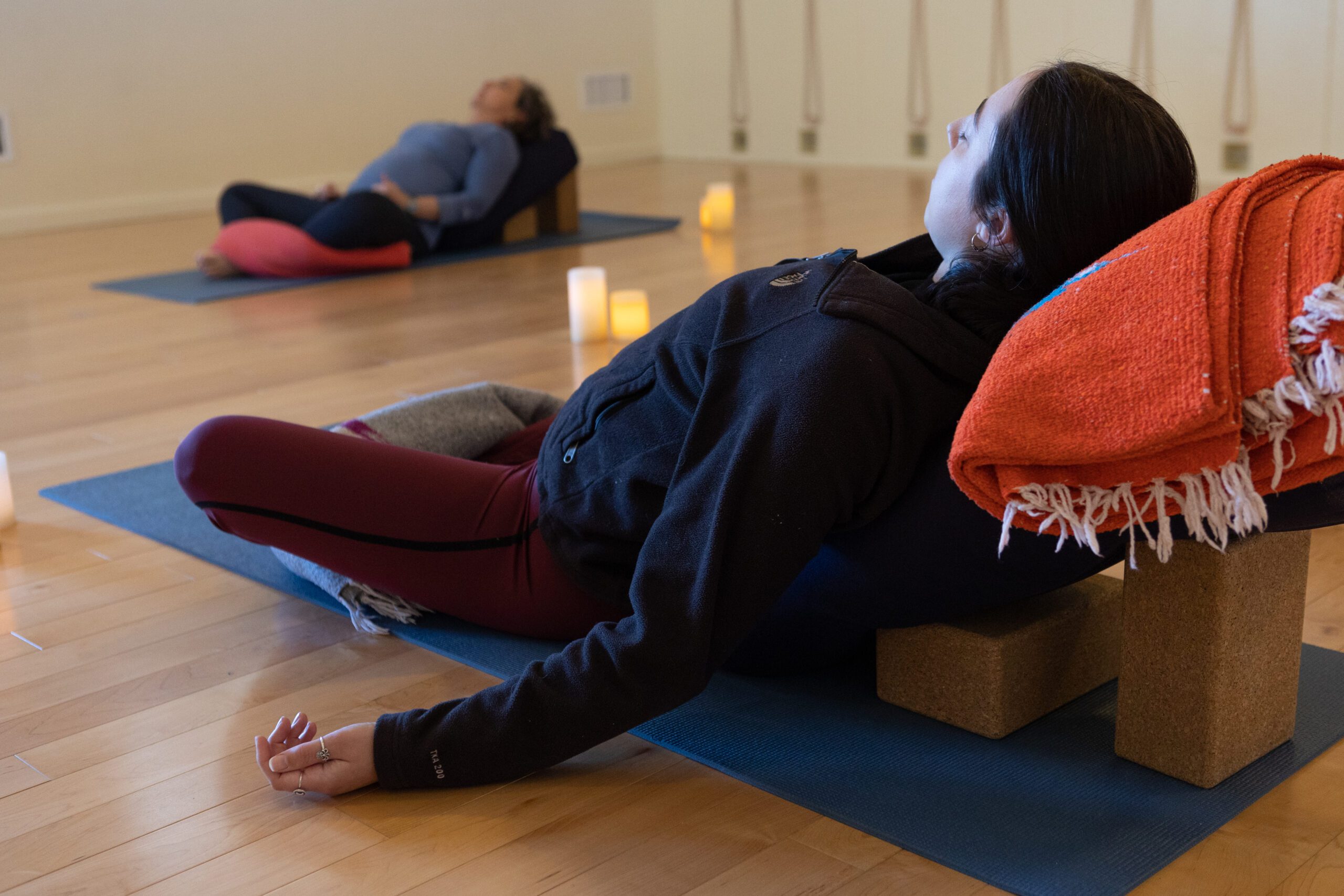 Women in Supta Baddha Konasana (reclining bound angle pose)